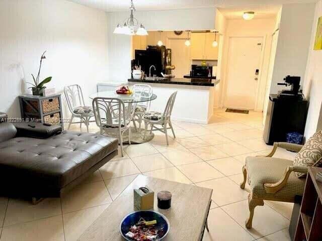 tiled living room with a chandelier