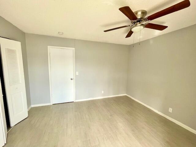 unfurnished room with ceiling fan and light hardwood / wood-style flooring