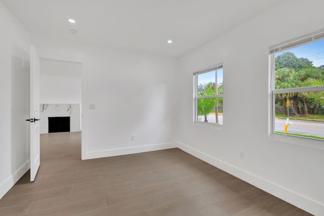 empty room with a premium fireplace and wood-type flooring