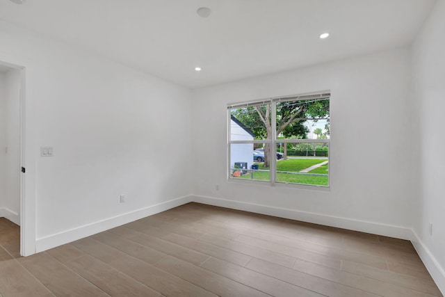 empty room with light hardwood / wood-style flooring