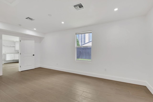 unfurnished room with wood-type flooring