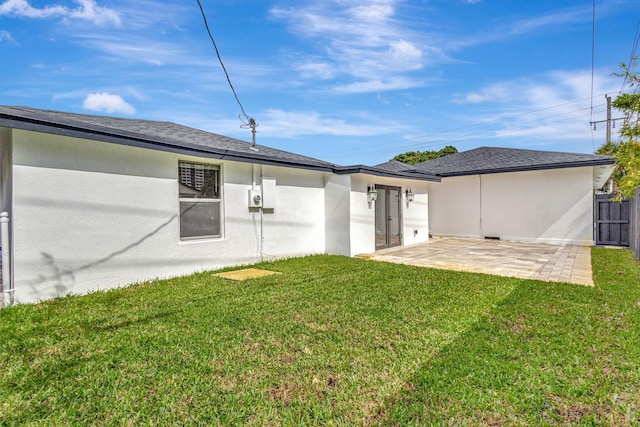 rear view of house featuring a yard and a patio area