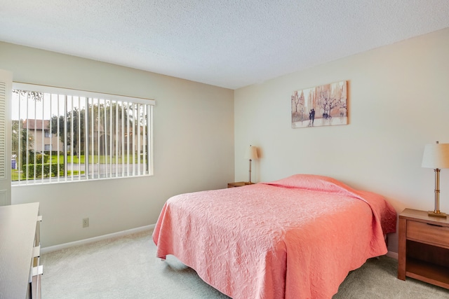 carpeted bedroom with a textured ceiling