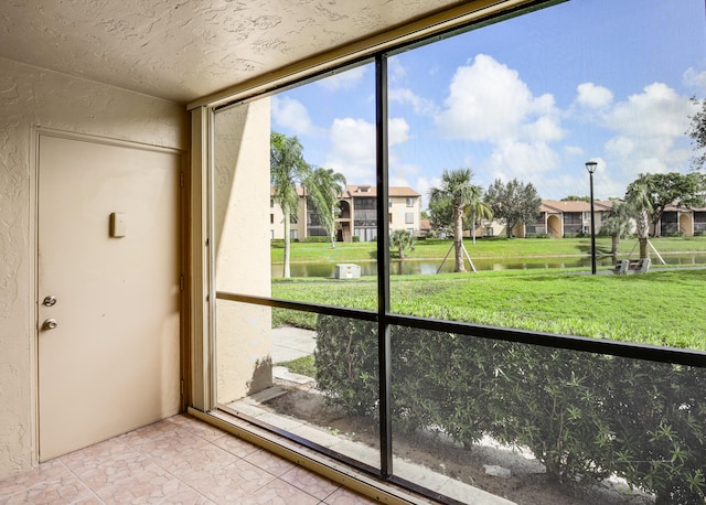 entryway featuring a water view and plenty of natural light