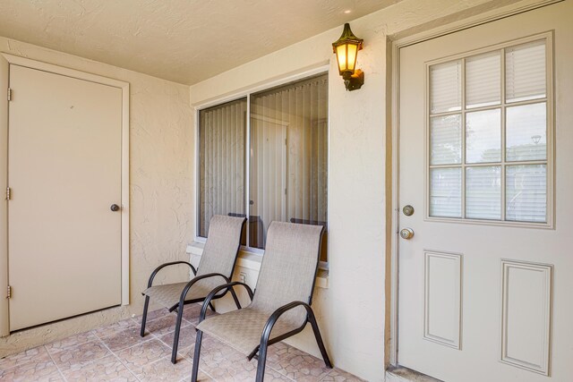 doorway to property with a lawn