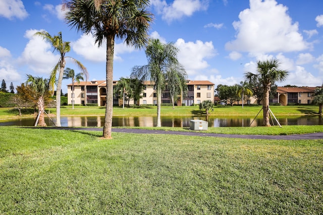 view of property's community with a water view and a yard