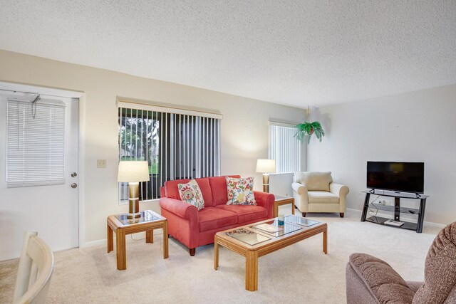 living room featuring a textured ceiling and carpet floors