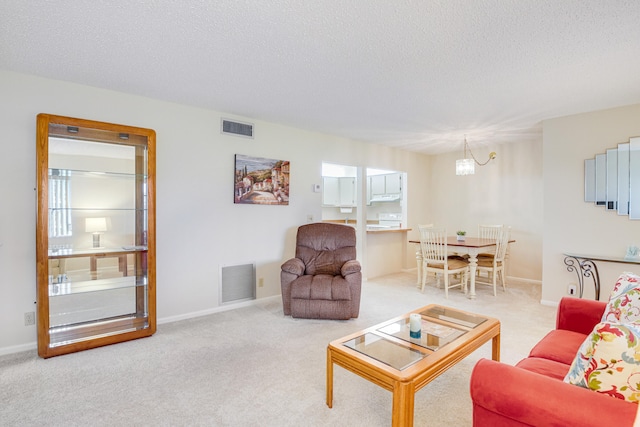 living room featuring carpet flooring and a textured ceiling