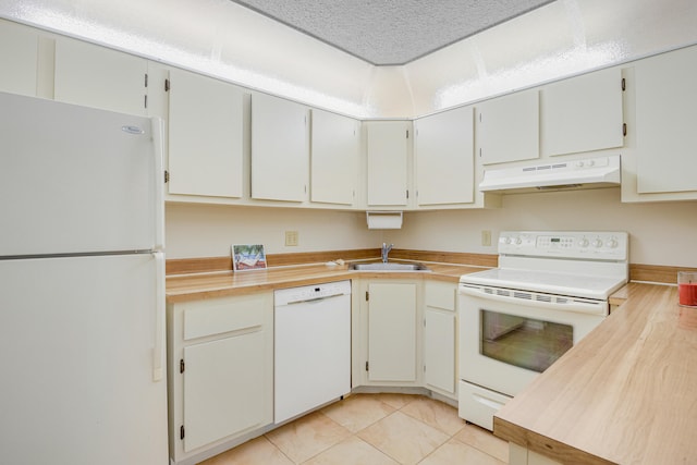 kitchen featuring white cabinetry, sink, white appliances, and light tile patterned floors