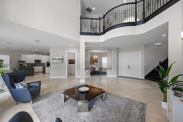 living room with a high ceiling and a chandelier