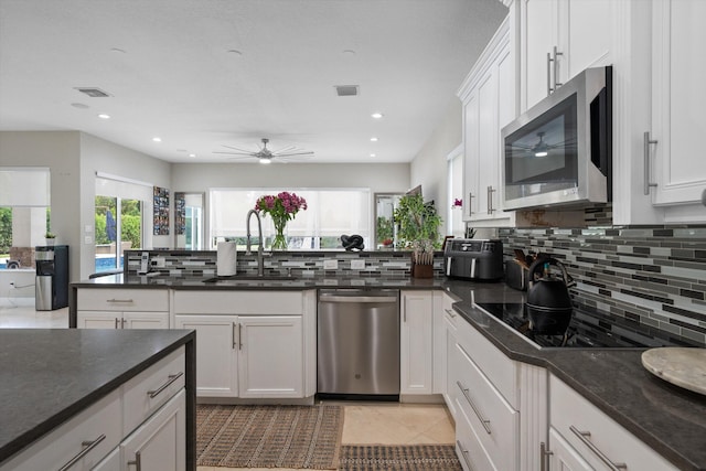 kitchen with white cabinetry, stainless steel appliances, and plenty of natural light