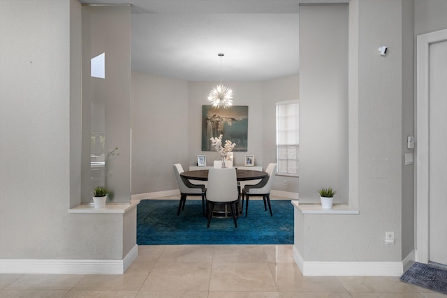 tiled dining space with a chandelier