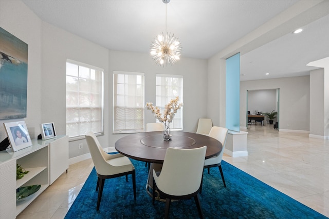 dining area with an inviting chandelier