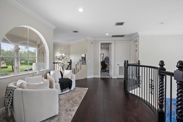 interior space with ornamental molding and dark hardwood / wood-style floors