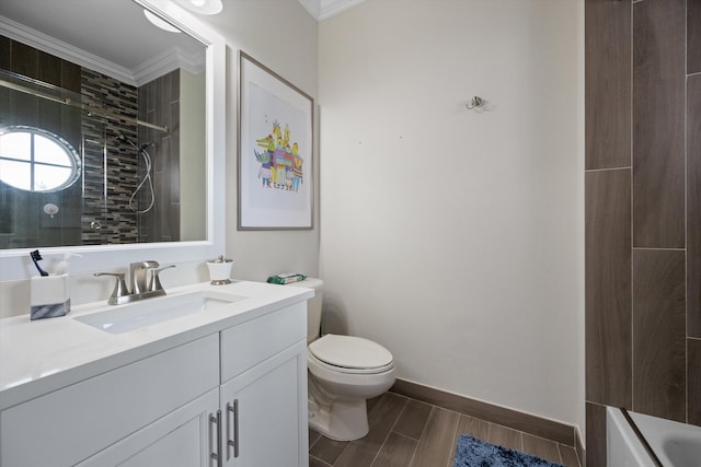 bathroom with vanity, a tile shower, and crown molding