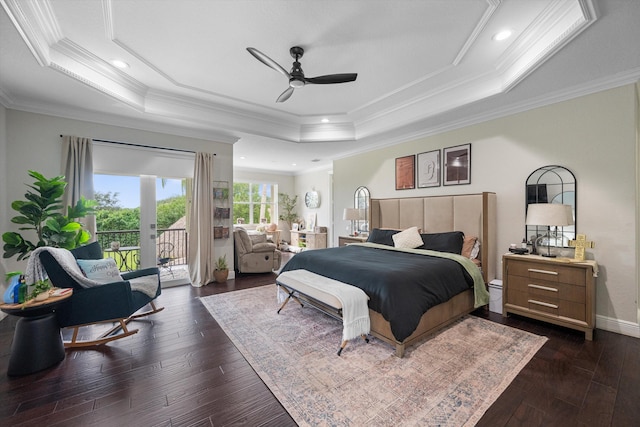 bedroom with dark wood-type flooring, ceiling fan, a tray ceiling, and ornamental molding