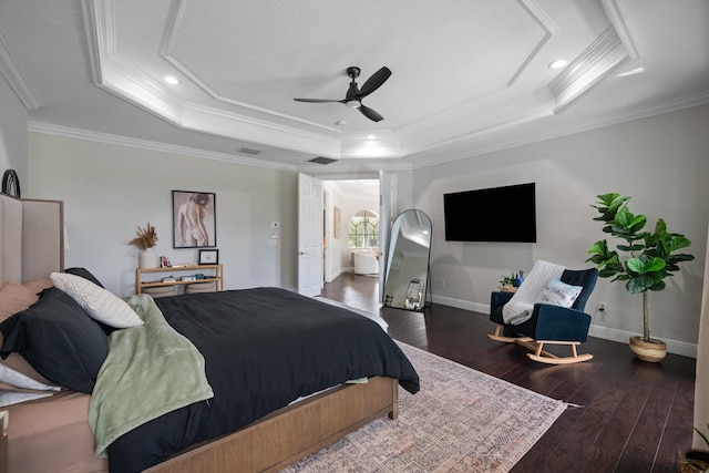 bedroom with ornamental molding, a tray ceiling, hardwood / wood-style flooring, and ceiling fan