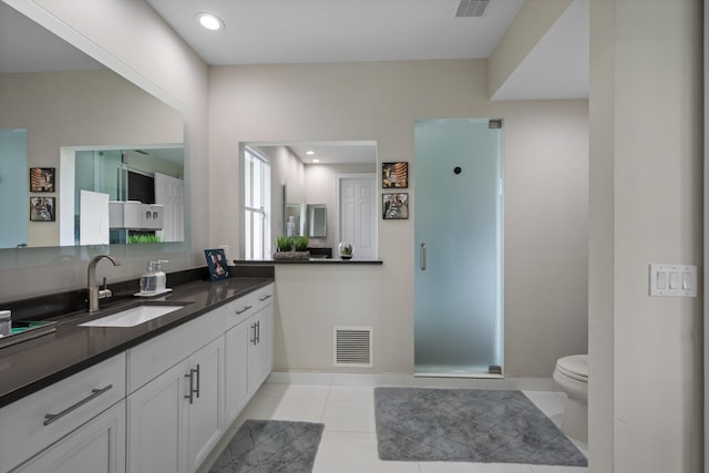 bathroom featuring tile patterned flooring, vanity, and toilet