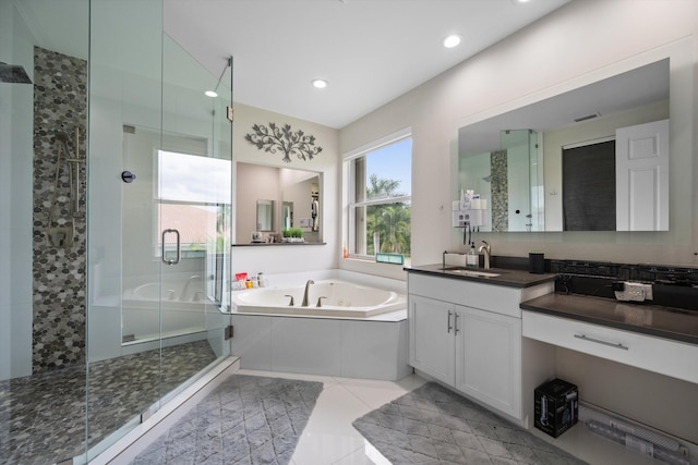 bathroom featuring vanity, tile patterned floors, and plus walk in shower