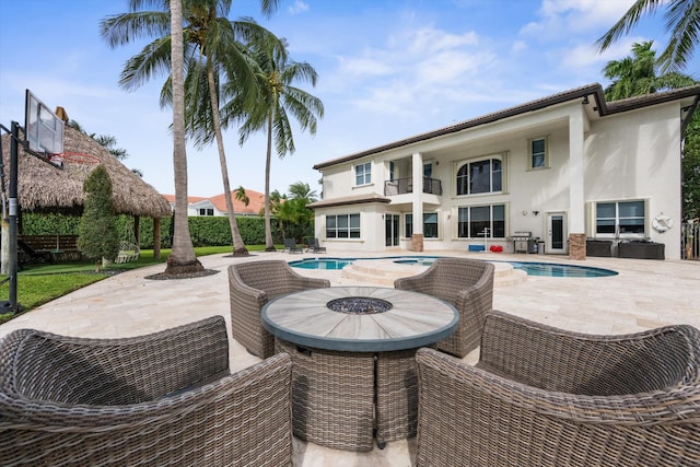 view of swimming pool featuring a patio, a hot tub, and grilling area