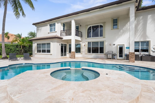 view of pool featuring grilling area, an in ground hot tub, and a patio area