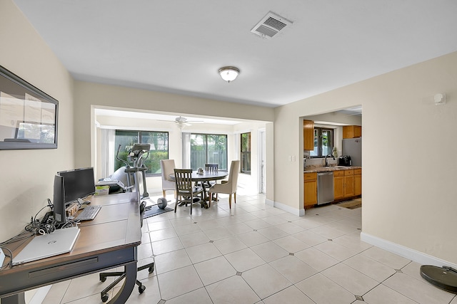 office featuring ceiling fan, light tile patterned floors, and sink