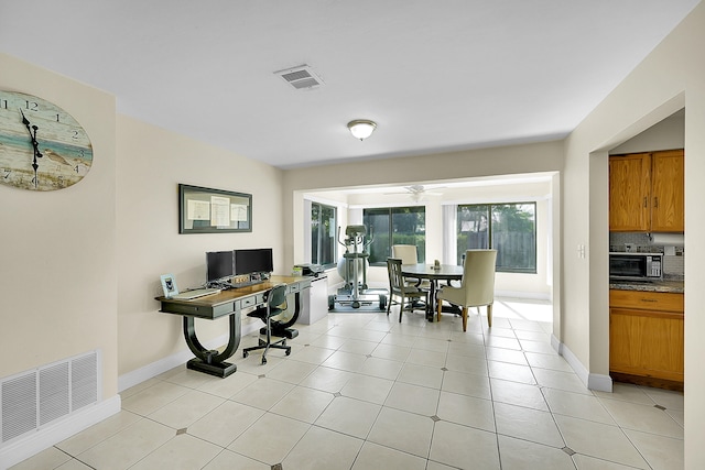 office area with light tile patterned flooring and ceiling fan