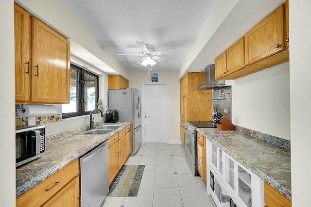 kitchen featuring appliances with stainless steel finishes, light tile patterned floors, sink, and stone counters