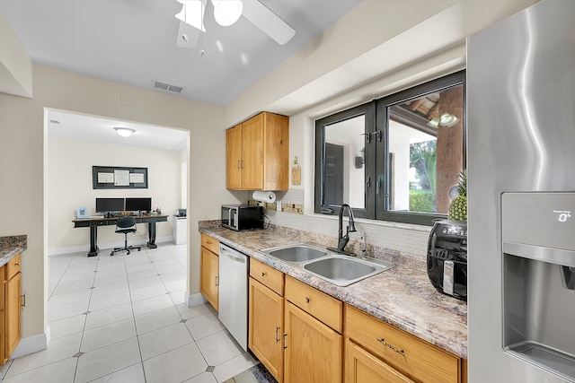 kitchen with stainless steel appliances, light tile patterned flooring, ceiling fan, and sink