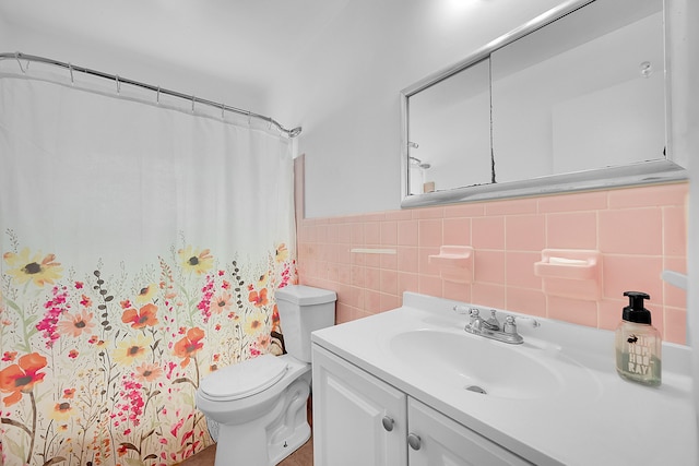 bathroom with tile walls, vanity, toilet, and a shower with shower curtain