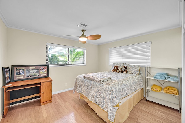 bedroom featuring ornamental molding, light hardwood / wood-style flooring, and ceiling fan