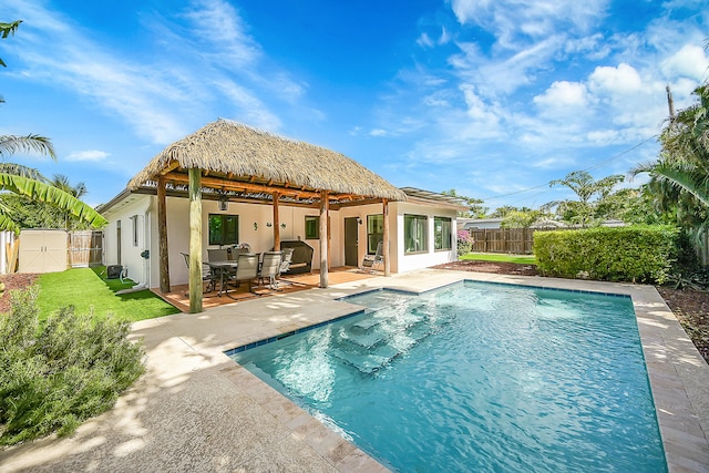 back of house featuring a patio and a fenced in pool