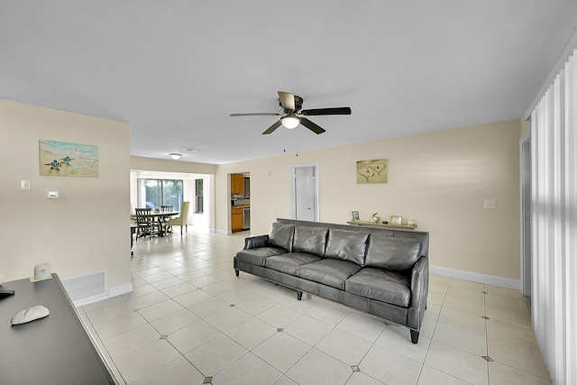 living room with ceiling fan and light tile patterned floors