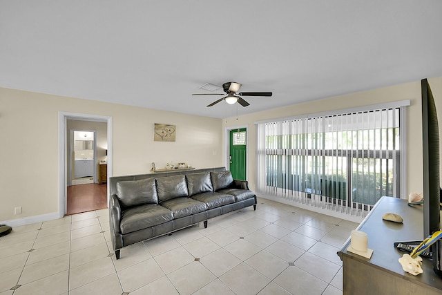 tiled living room featuring ceiling fan