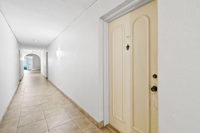 corridor featuring light tile patterned floors