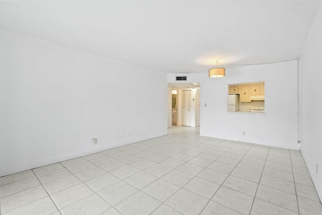 empty room with light tile patterned floors