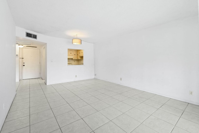 empty room featuring light tile patterned floors