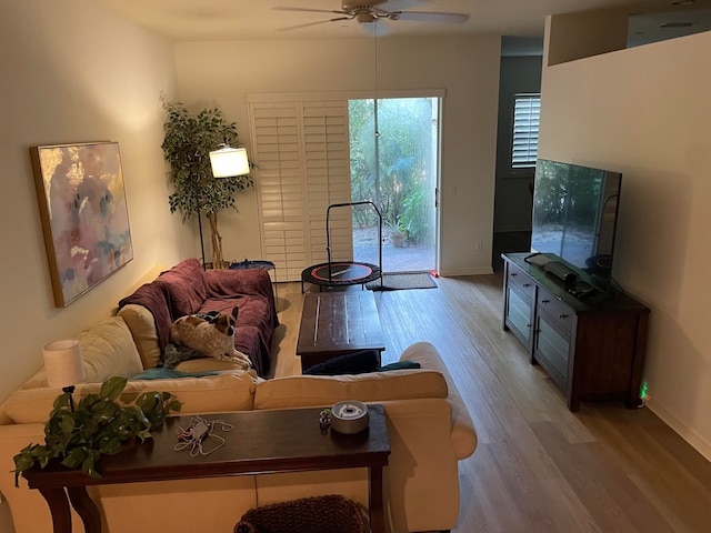 living room featuring light hardwood / wood-style flooring and ceiling fan