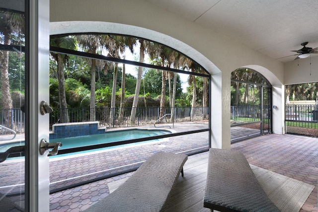 view of swimming pool featuring ceiling fan and a patio