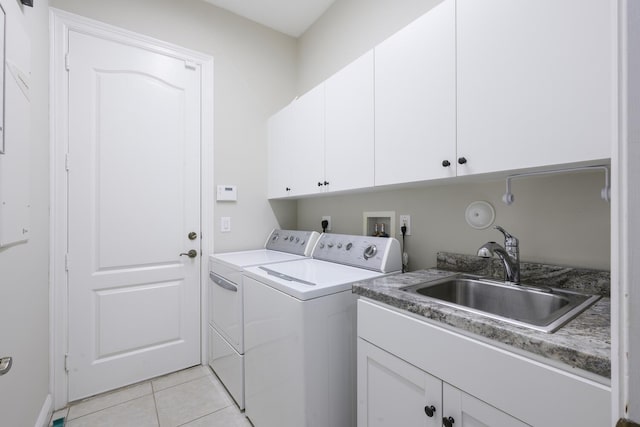 laundry area featuring cabinets, separate washer and dryer, sink, and light tile patterned flooring