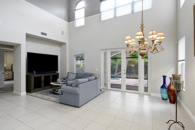 tiled living room featuring a notable chandelier and a high ceiling