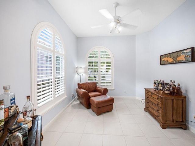 living area featuring ceiling fan and light tile patterned floors