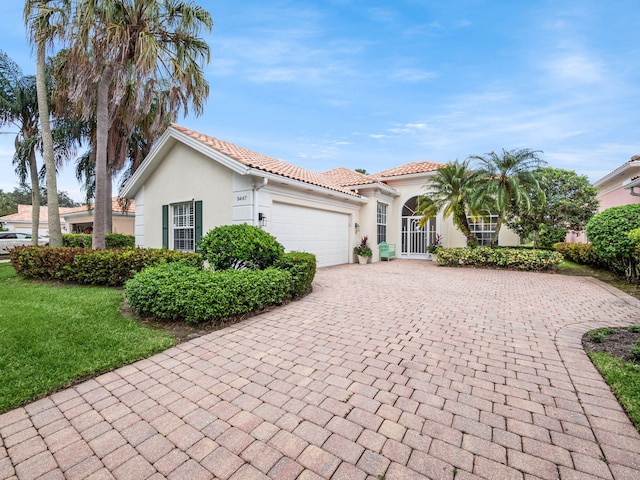 view of front of home with a front lawn and a garage