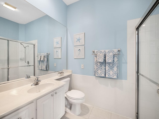 bathroom with an enclosed shower, vanity, tile patterned floors, and toilet