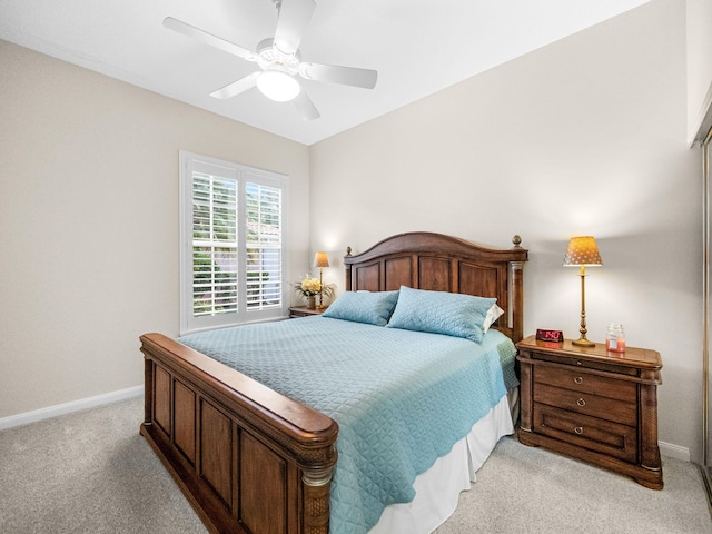 bedroom featuring light colored carpet and ceiling fan