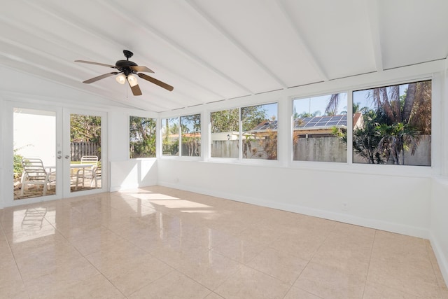 unfurnished sunroom with lofted ceiling, ceiling fan, and french doors