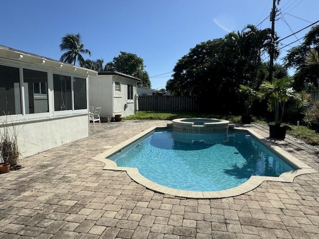 view of swimming pool featuring a patio and an in ground hot tub