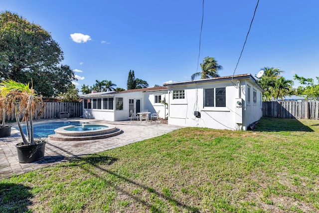 back of property with a lawn, a patio area, a fenced backyard, and stucco siding