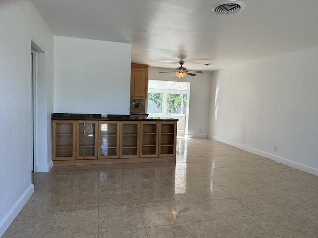 unfurnished living room featuring ceiling fan