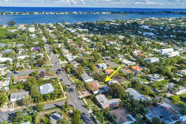 drone / aerial view with a water view and a residential view